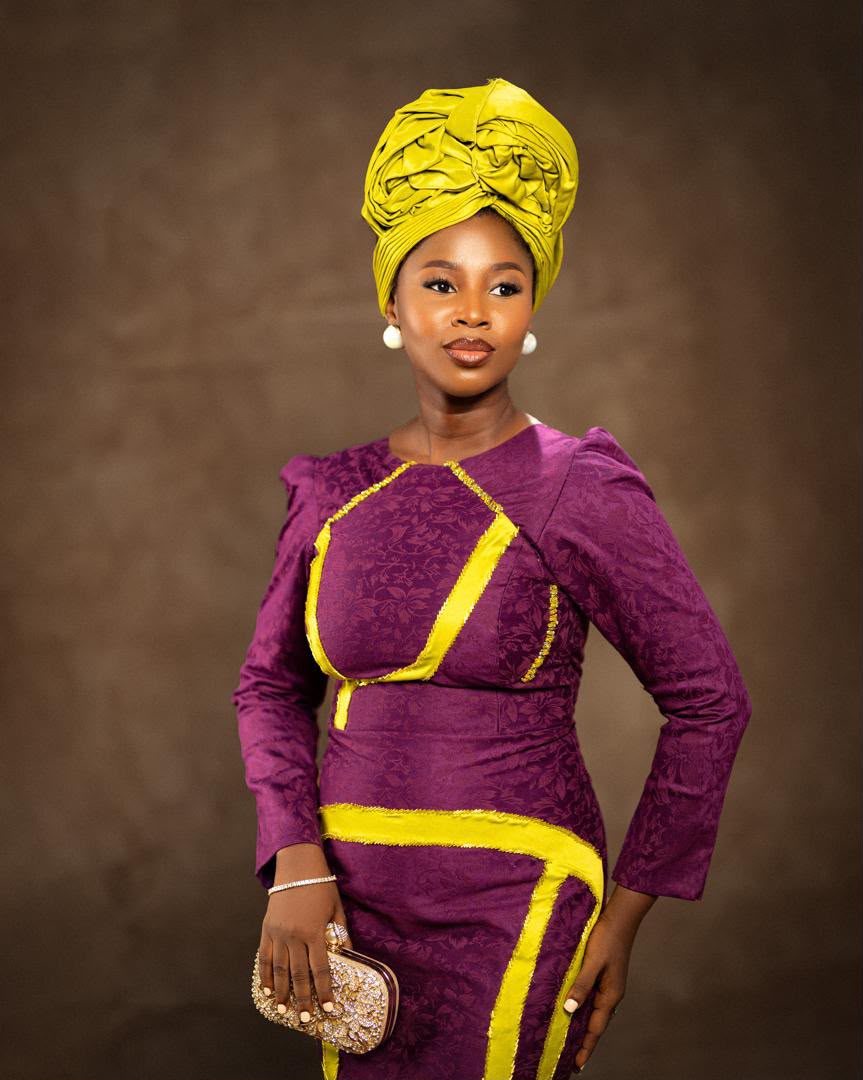 Portrait of a lady in a purple gown with a yellow headwrap