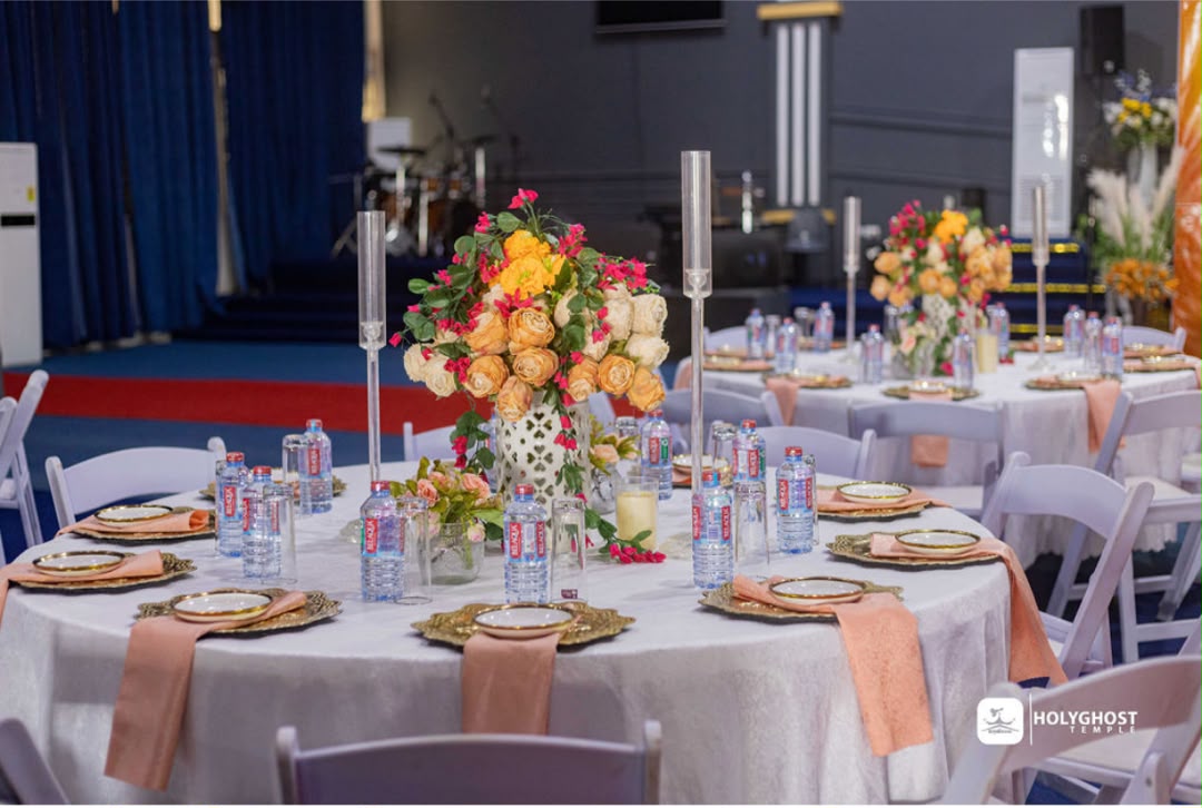 Hall reception with tall floral centerpiece and peach napkins